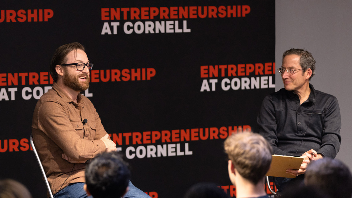two people on chairs in front of a room