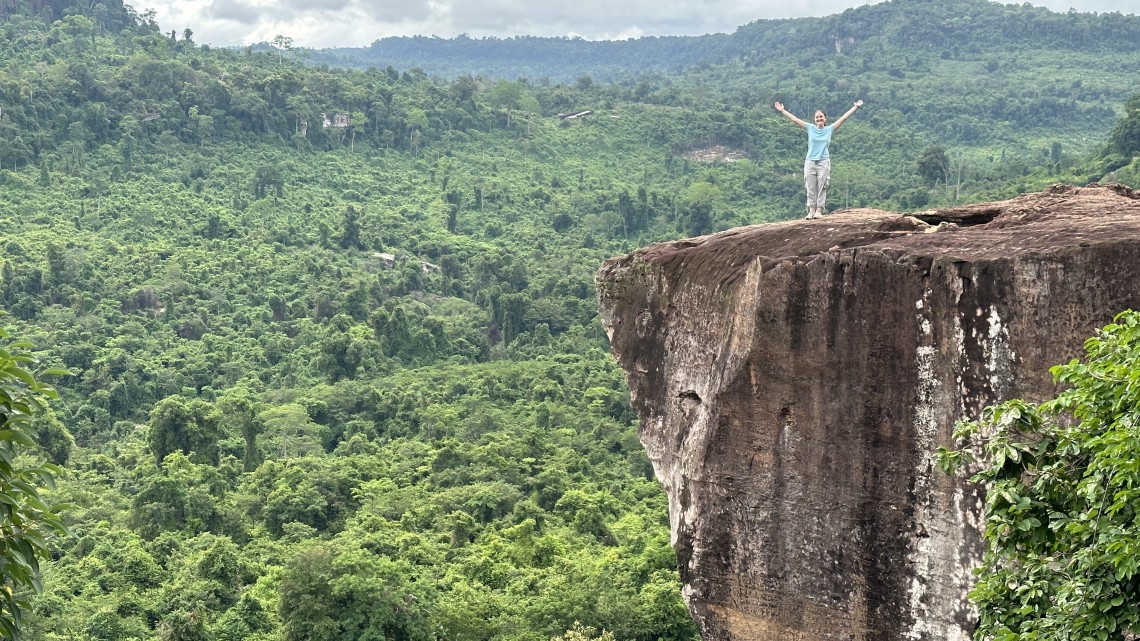 Emma Alexander poses atop at the top of Phnom Kulen Mountain. 