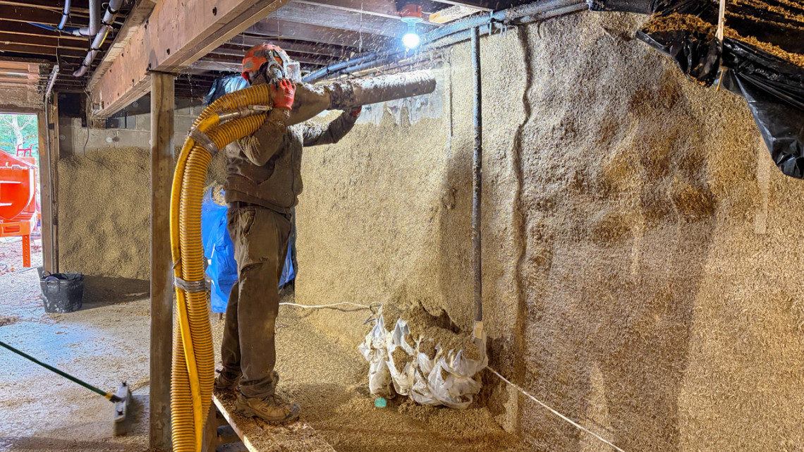 Builder Jeff Gagnon uses the Ereasy spray system - recently purchased by Cornell for community use - to insulate a basement in Ulster County with hemp lime, a composite of hemp hurd and lime binder.