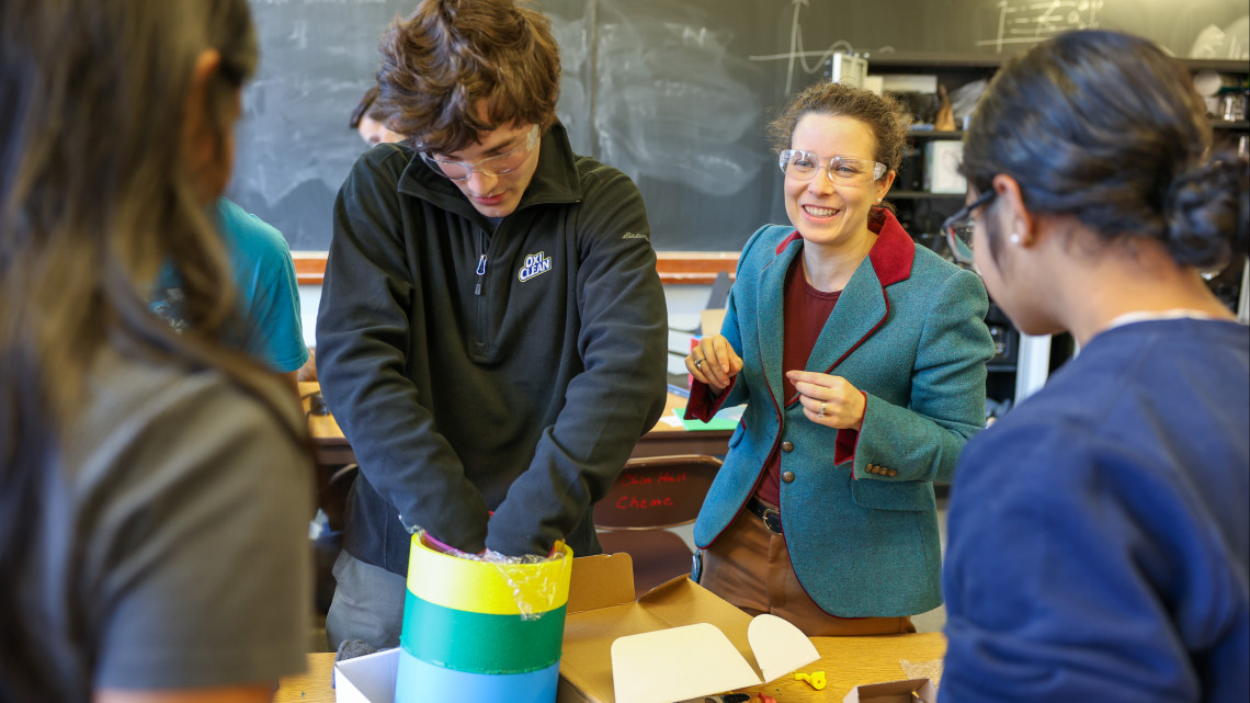 professor with three students in a classroom