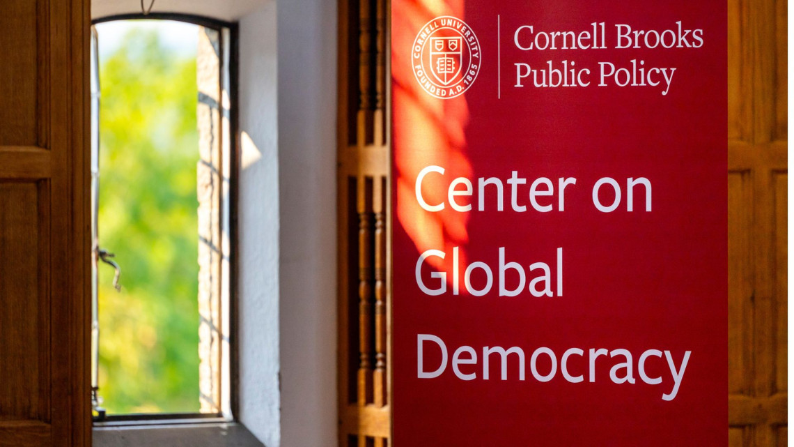 Red popup banner near an open window with the the text Center on Global Democracy, Cornell Brooks Public Policy
