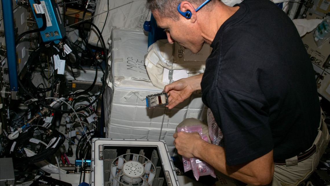Michael Scott Hopkins performs a microgravity experiment on the International Space Station.