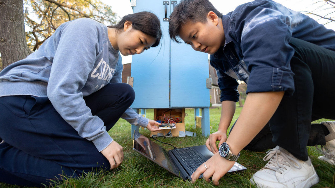 Students inspect their outdoor food pantry in 2022.