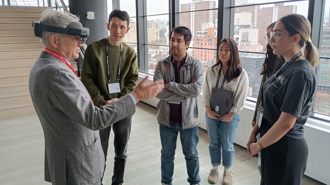 Team Spiny Senses works with Weill Cornell Medicine neurosurgeon Dr. Roger Härtl, left, to develop a system designed to modernize scoliosis screening during the Cornell health AI Hackathon. The team won the hackathon's grand prize. 