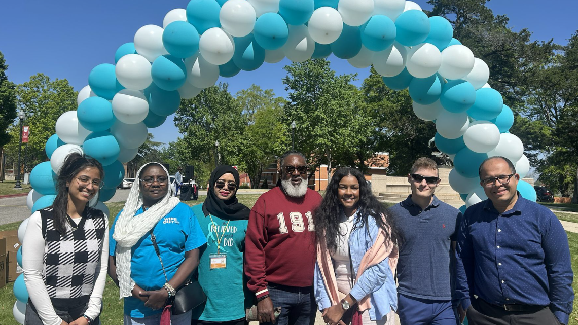 Group standing under balloons