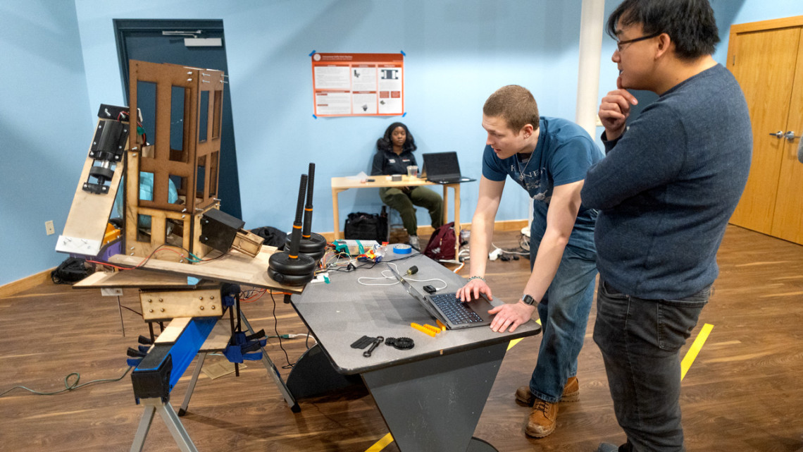 Students Thomas Vignos ’26, left, and Francis Xie ’28 demonstrate new hardware projects at the Sciencenter.