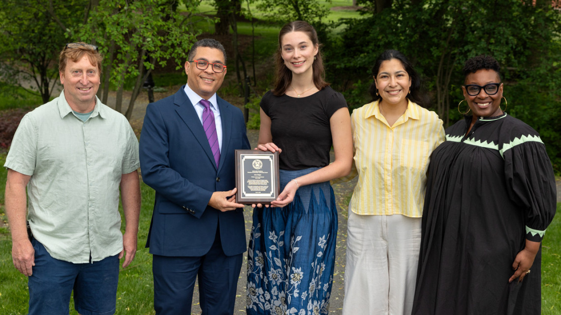 At center, holding her award, is Abra Geiger ’26, recipient of the 2026 University Relations Campus-Community Leadership Award. Left to right, with her are Erik Herman, creative director of the Free Science Workshop/Ithaca Physics Bus; Kyle Kimball, vice president for university relations; Cassaundra Guzman, McNair Program advisor/coordinator; and Marla Love, Robert W. and Elizabeth C. Staley Dean of Students.