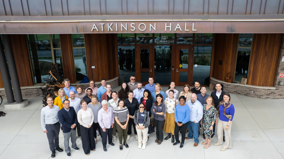 Members of the inaugural Resilient Futures Leadership Program cohort gather at Cornell University in front of Atkinson Hall. The six-month executive education program brought together professionals from across sectors to explore strategies for financing sustainable agriculture. 