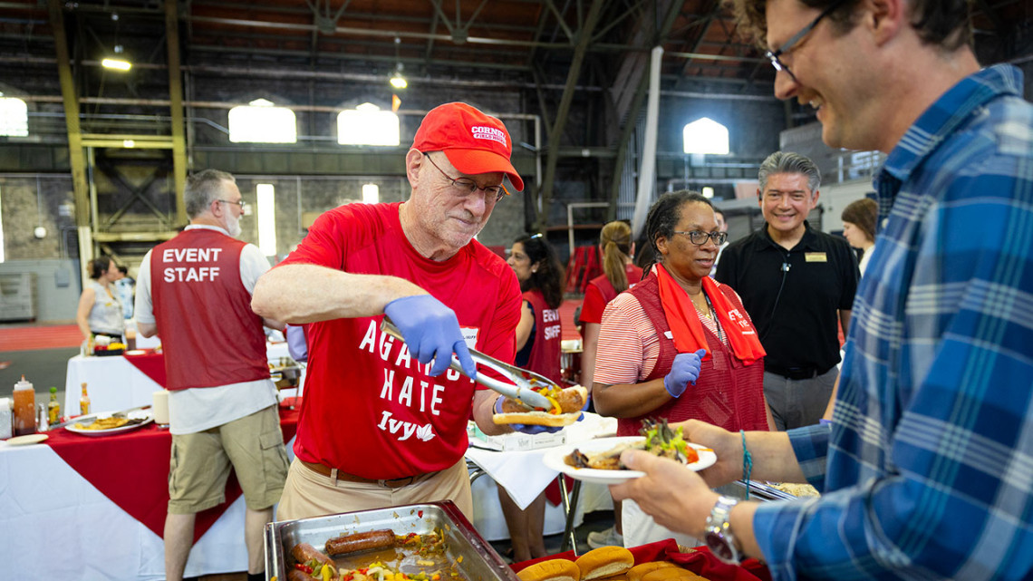 Cornell President Michael I. Kotlikoff serves lunch to employees at the 70th annual Service Recognition event July 1 in Barton Hall.