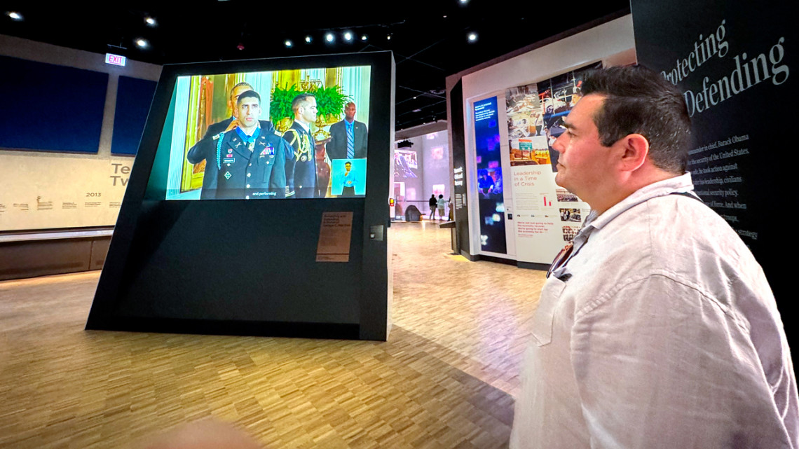 Jeffrey Palmer, associate professor in the Department of Performing and Media Arts, watches a film he produced at the Obama Presidential Center in Chicago.