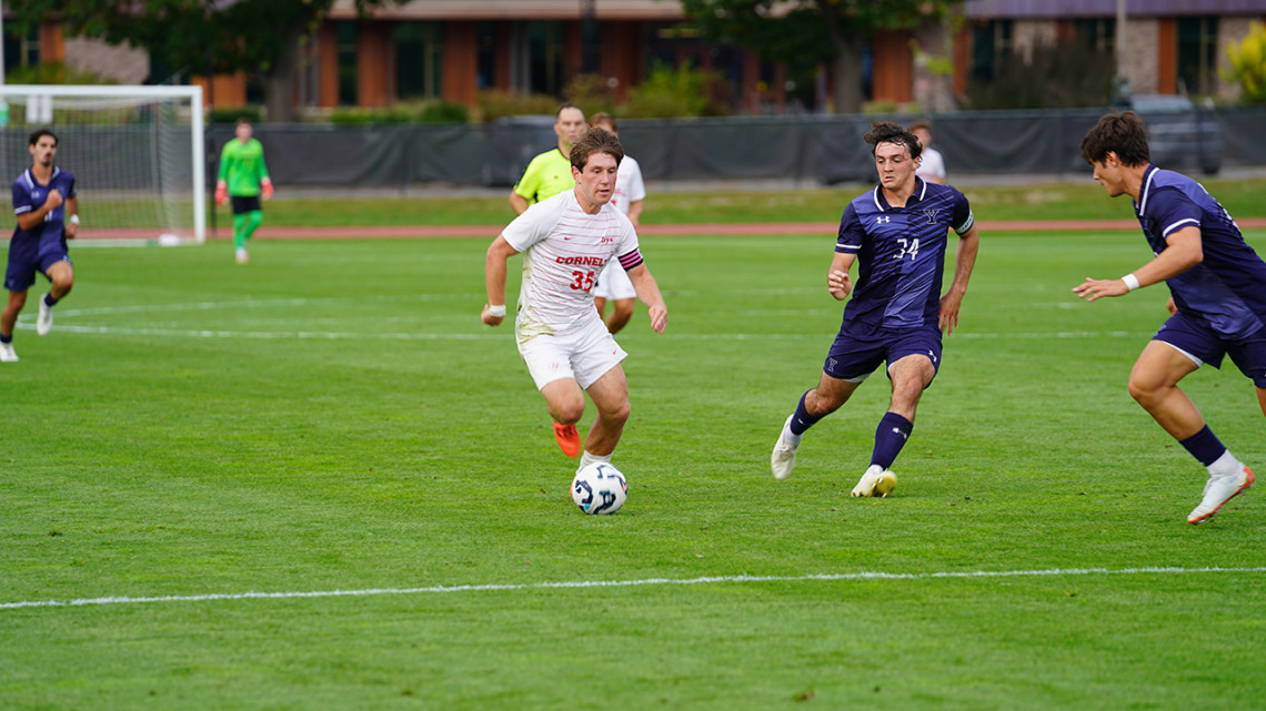Connor Miller ’27 dribbles around two defenders during the Cornell men’s soccer team’s 3-1 home win over Yale.