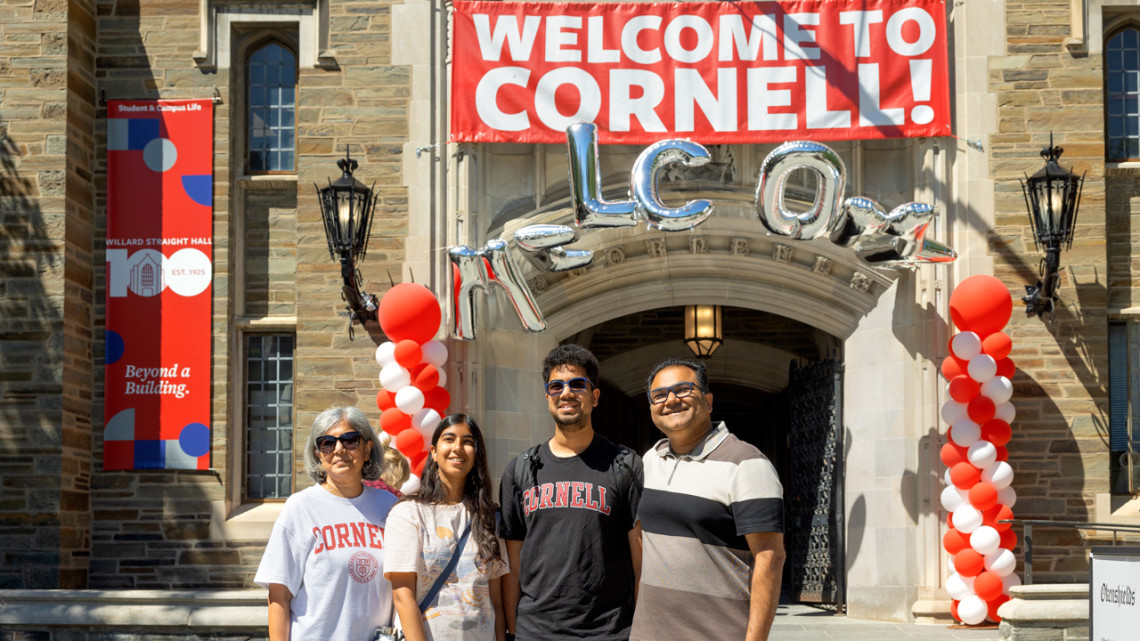 Family in front of Willard Strait Hall