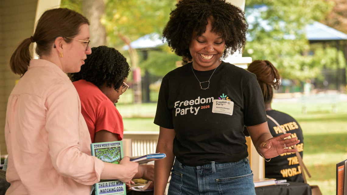 Two women discuss books at the 2025 Freedom Party.