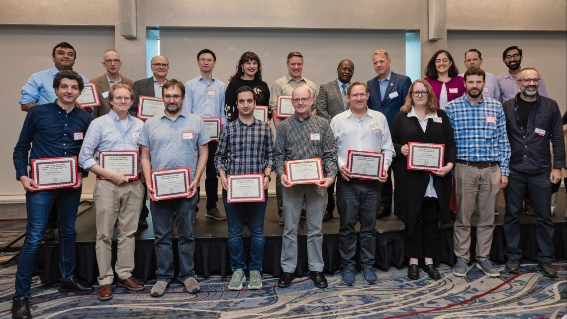 group of faculty holding certificates