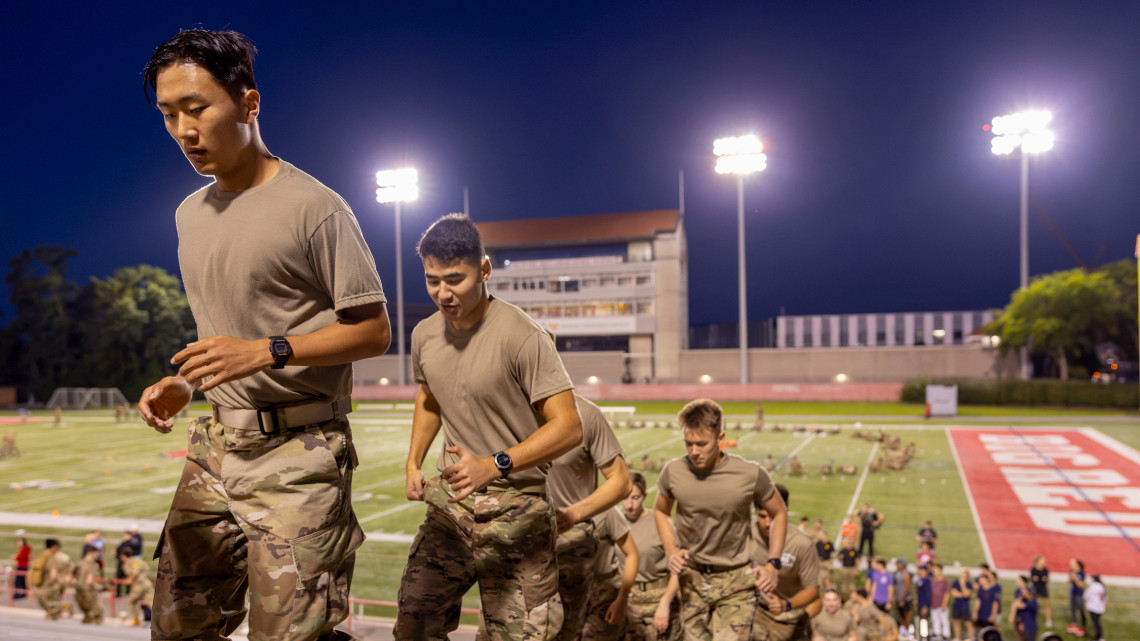 ROTC members running up stairs in Schoelkopf stadium before dawn