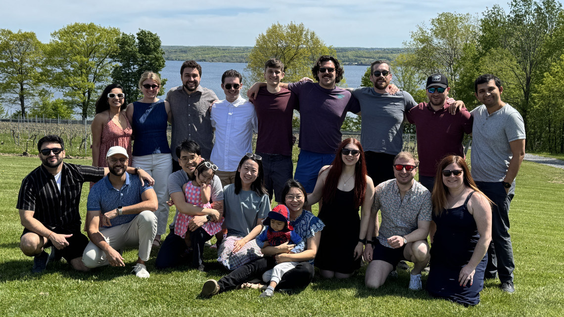 group of people pose at a vineyard