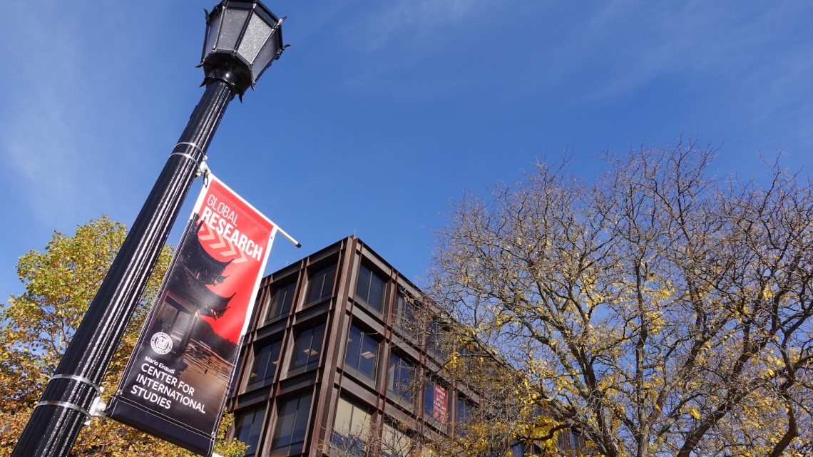 A banner on a lightpole in front of Uris Hall reads: "Global Research, Mario Einaudi Center for International Studies."