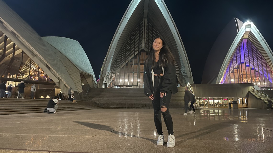 Allison Lee stands in front of the Sydney Opera House.