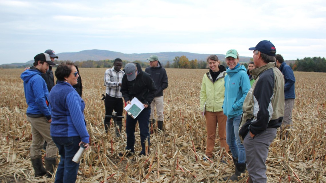 image of researchers meeting in a field