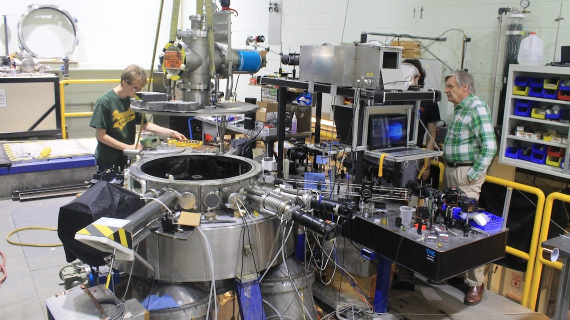 researchers operate lab equipement