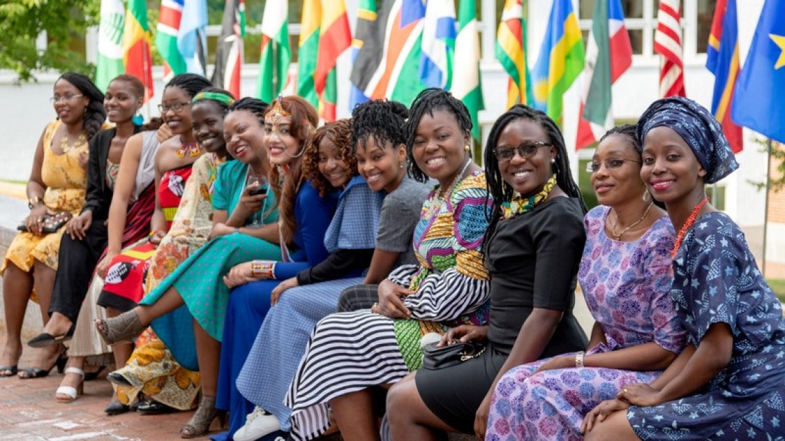 Participants in Mandela program sit on ledge at Dartmouth College