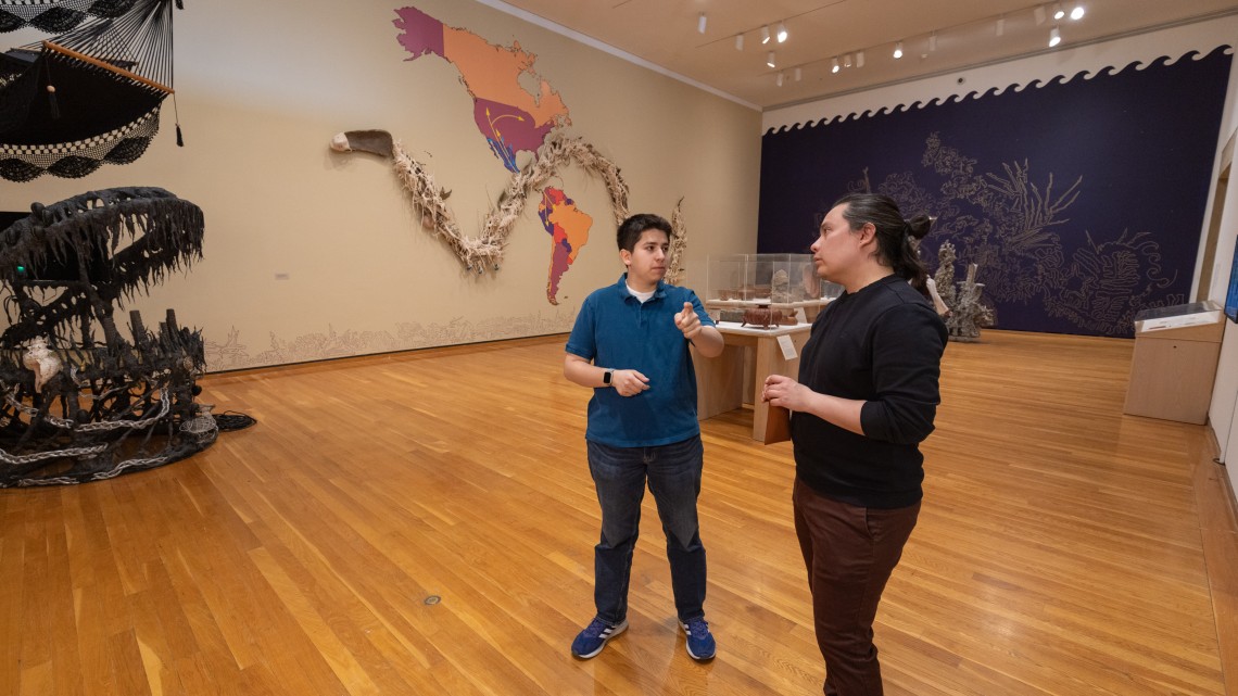 two people standing in a museum exhibit