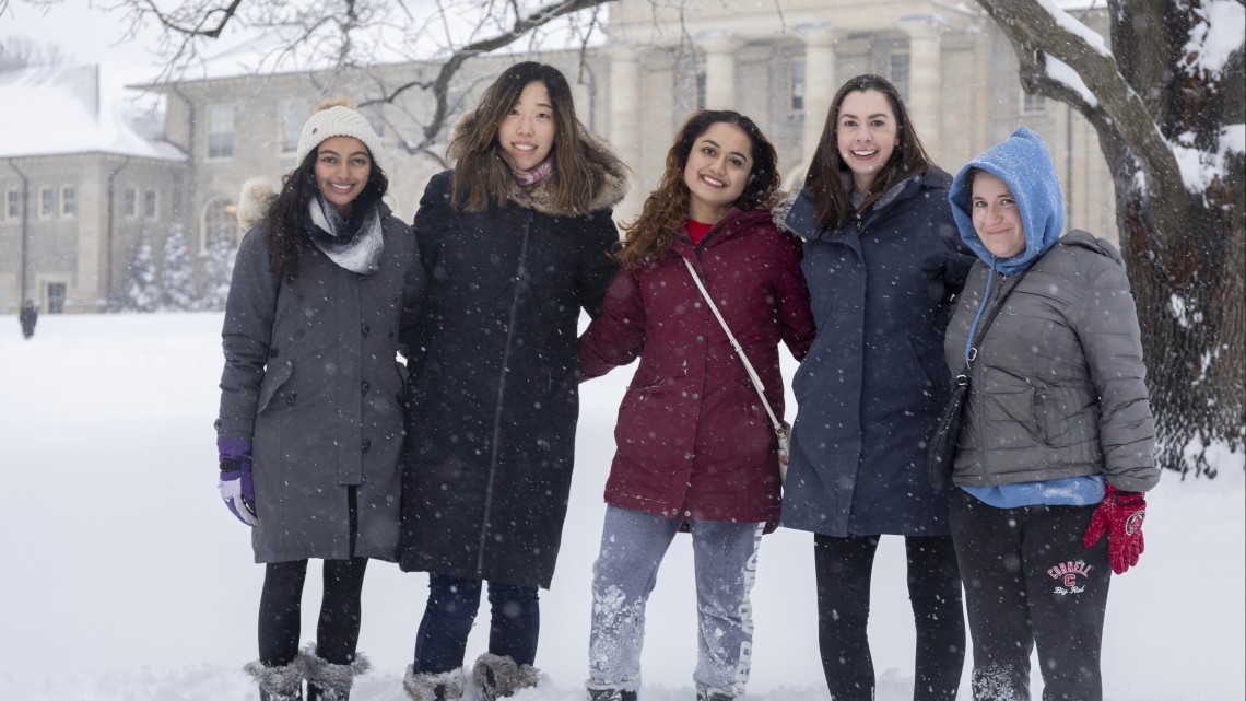 Smiling Cornell students in the snow 
