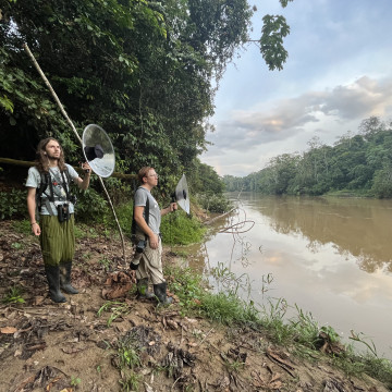 Researchers in Ecuador hold up tools to record bird sounds in Ecuador.