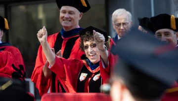 President Martha E. Pollack cheering graduates. 