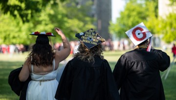 Graduates don their customized caps.