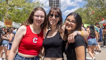Three women pose for a photo on Ho Plaza. 