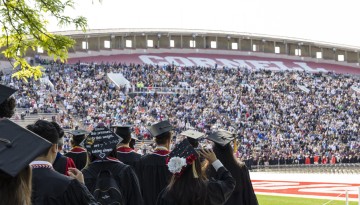 Graduates and their families celebrate together during the 2023 Commencement ceremony at Schoellkopf Field.