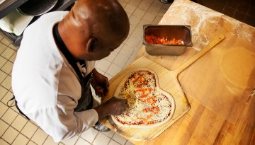 James Gilbert arranges a heart-shaped pizza for Valentines Day in Appel Commons.