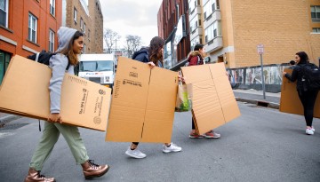 Students carry boxes through Collegetown