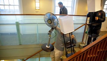 Student with fan walking down stairs