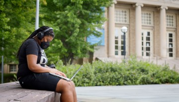 A student attends a virtual class on Bailey Plaza during the first day of classes.