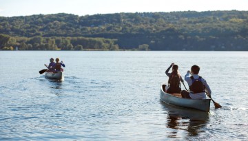 Canoes head out on Cayuga Lake at Merrill Family Sailing Center for a class with Cornell Outdoor Education.