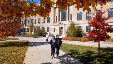 Students are greeted by the afternoon sun outside Warren Hall.