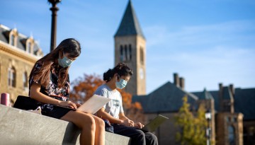 Students study an the top of Libe Slope on a warm afternoon.