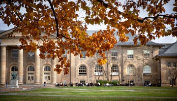 Students take advantage of the outdoor tables in front of Goldwin Smith Hall.