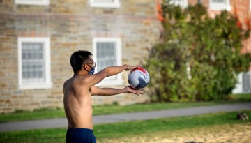 Students play sand volleyball