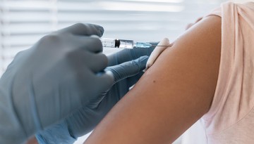 A patient receives a vaccination from a doctor