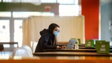A student works in the Human Ecology Commons. 