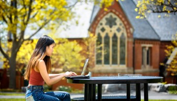 A student works near Sage Chapel.