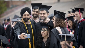 Graduates pose for a selfie. 