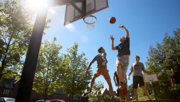 MBA students play basketball on West Campus.