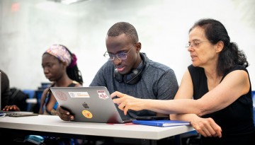 Éva Tardos, the Jacob Gould Schurman Professor of Computer Science, works with students during the 2021 CSMore class in Gates Hall.
