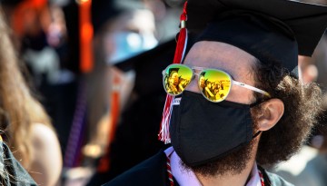 A graduate wearing reflective sunglasses. 