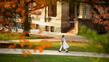 A student passes by Sibley Hall.