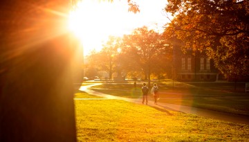 Students walk back from class at golden hour.